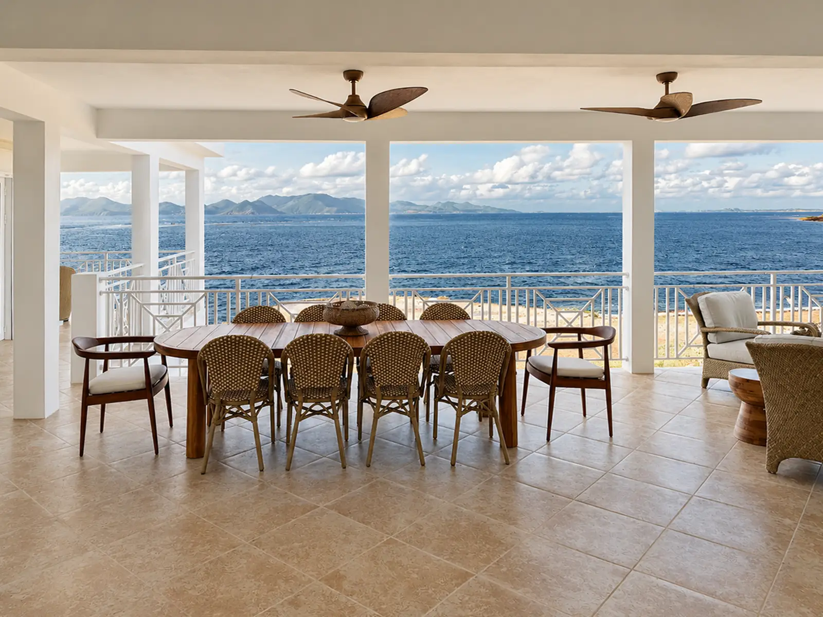 Villa Bénie upper patio — lounge seating and sea views
