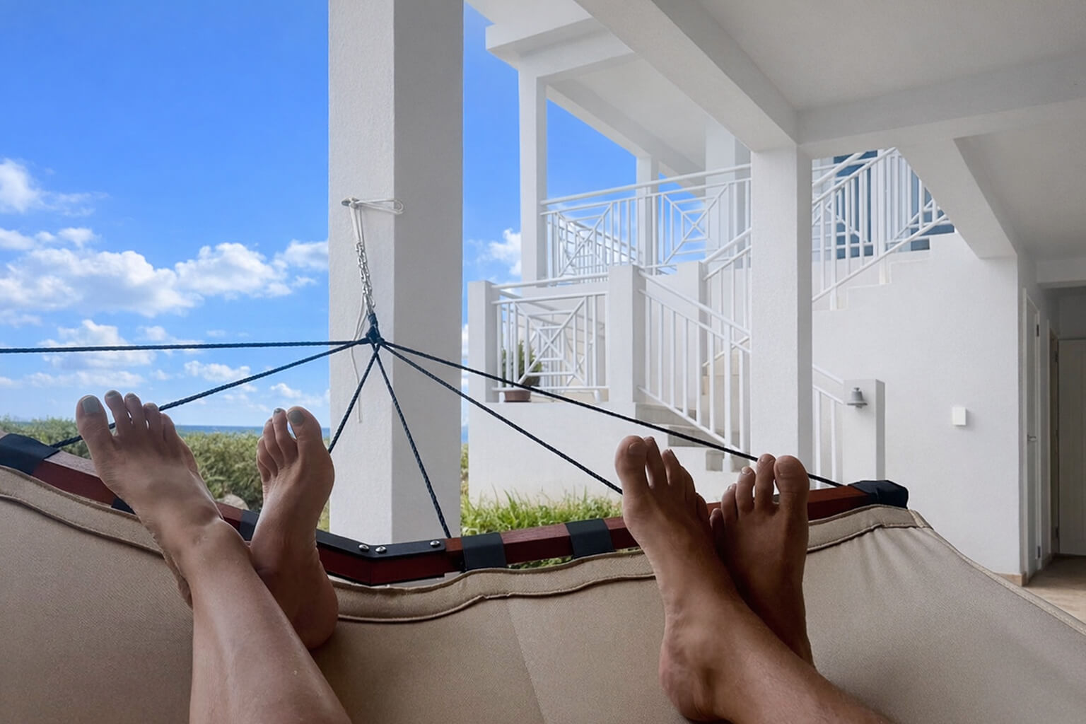 The Lower Patio — two-person hammocks, lounge chairs, shaded and private with ocean views