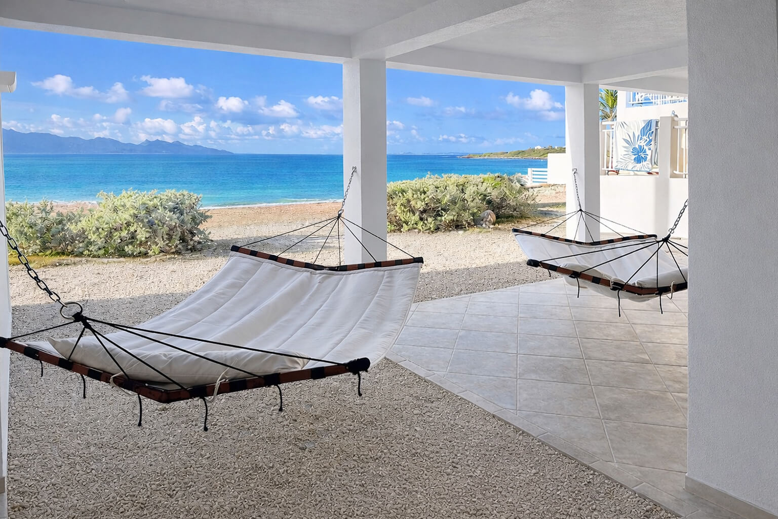 The Lower Patio — small dining table, sound of the sea, views toward St. Martin