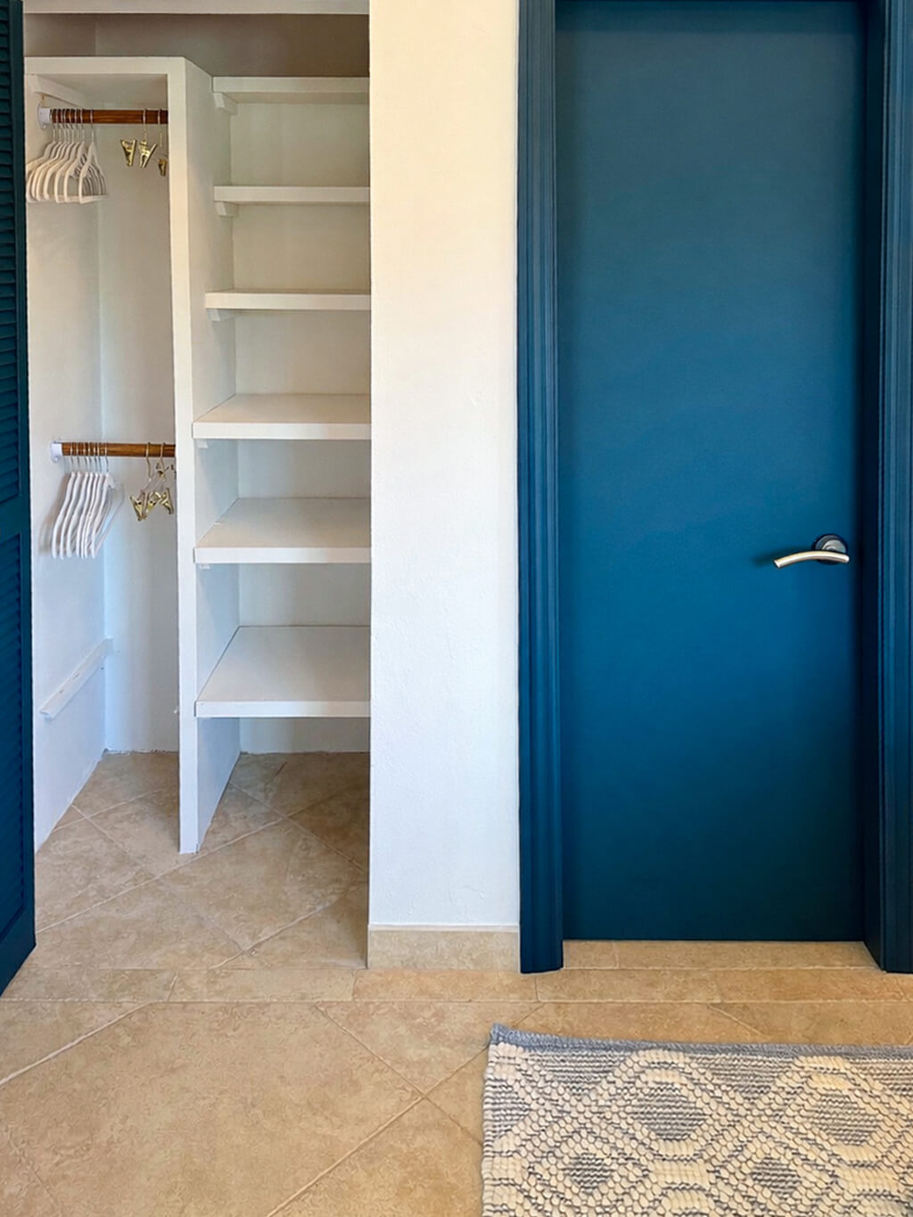 Reef Retreat detail — layered king bed and warm textures