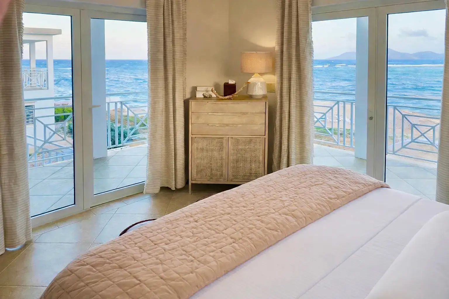 Sunrise bedroom — king bed with sea and sky views