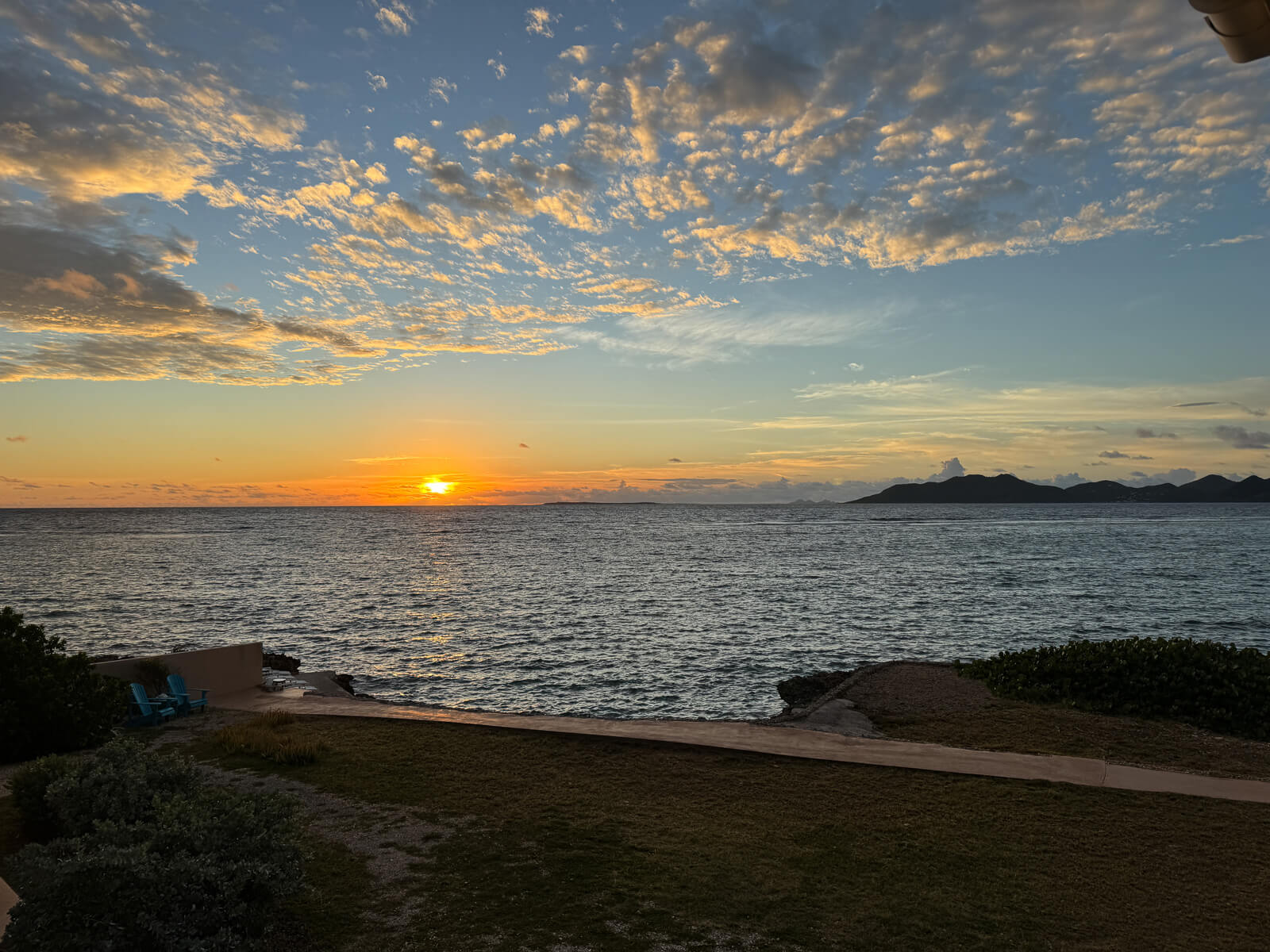 The Dock — Adirondack chairs at the water's edge, sweeping views of St. Martin