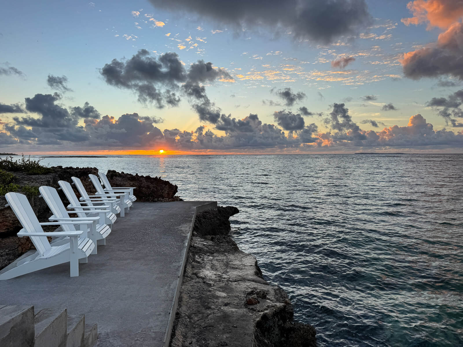 The Dock — morning calm, Adirondack chairs awaiting the day