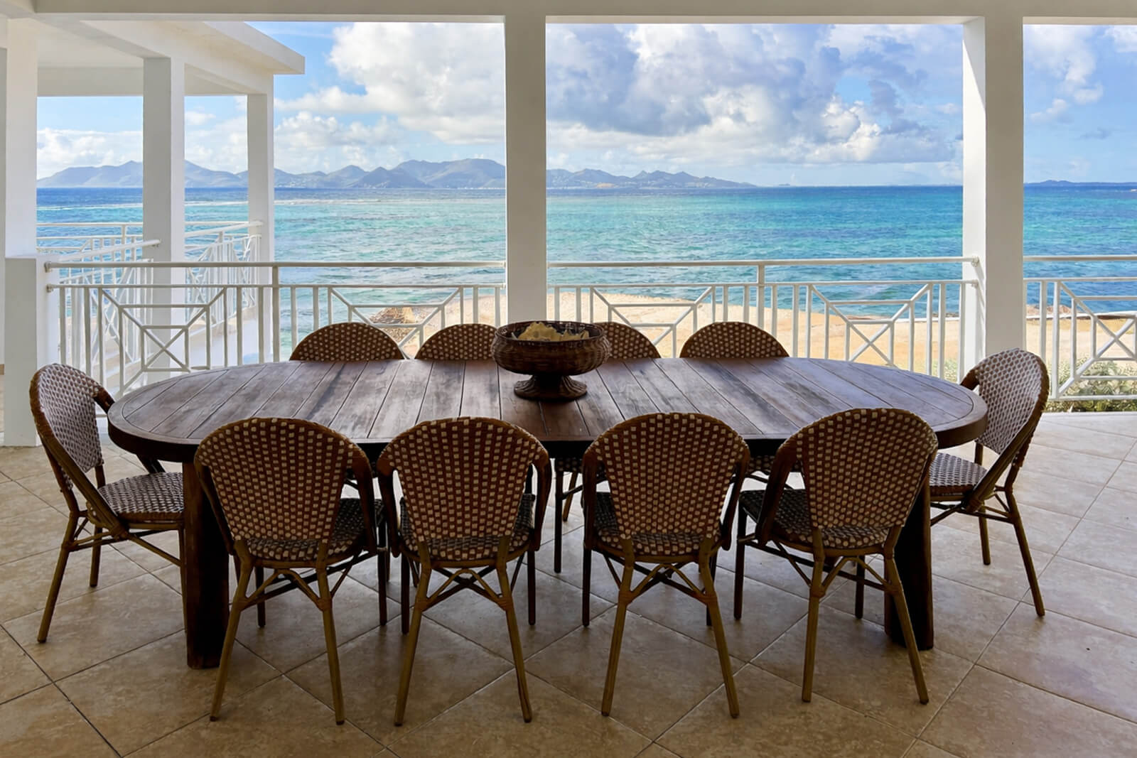 Upper Patio — gathering space with reef sound and ocean backdrop